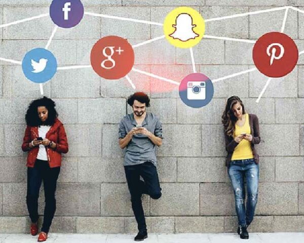 Image of people interacting with their cell phones with the social network logos above