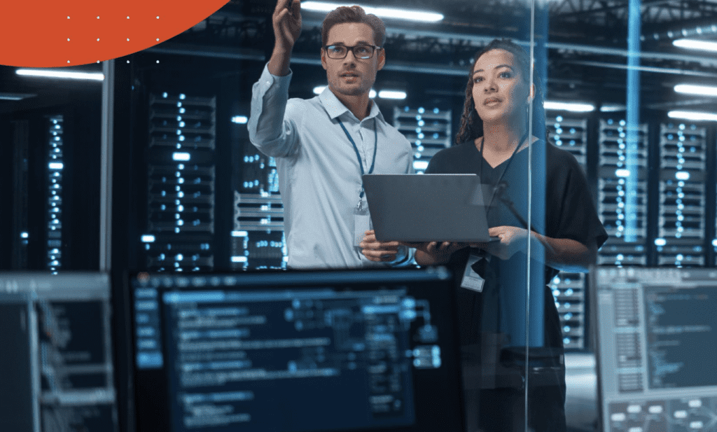 Two people in an IT infrastructure room