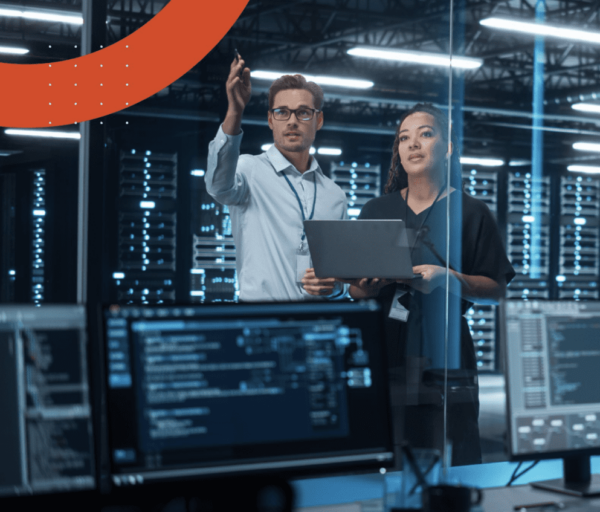 Two people in an IT infrastructure room