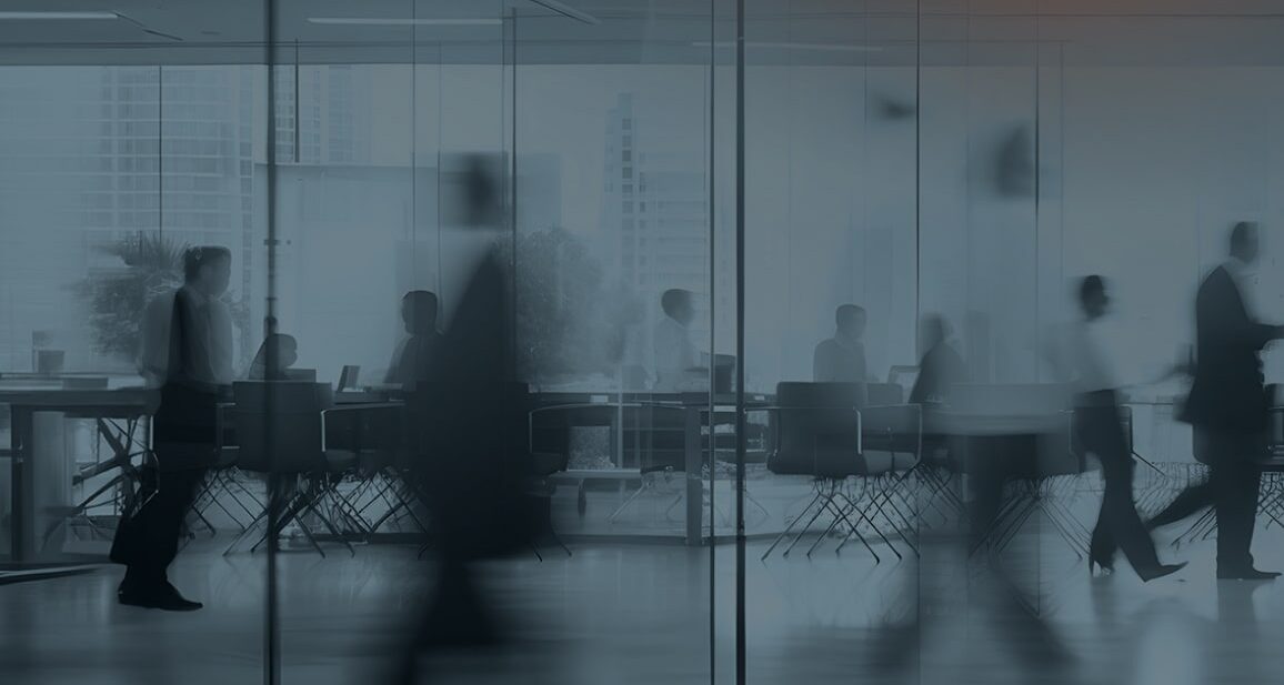 Blurred people walking in an office