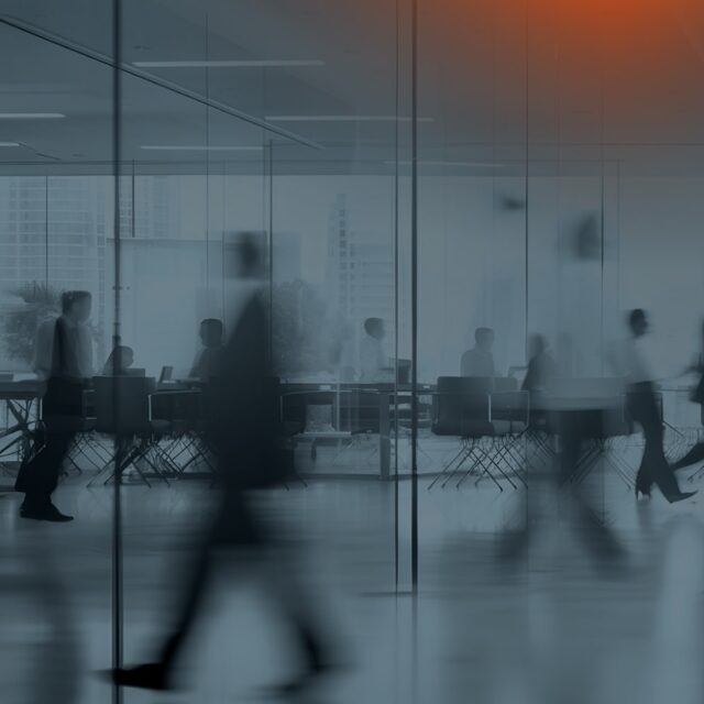 Blurred people walking in an office