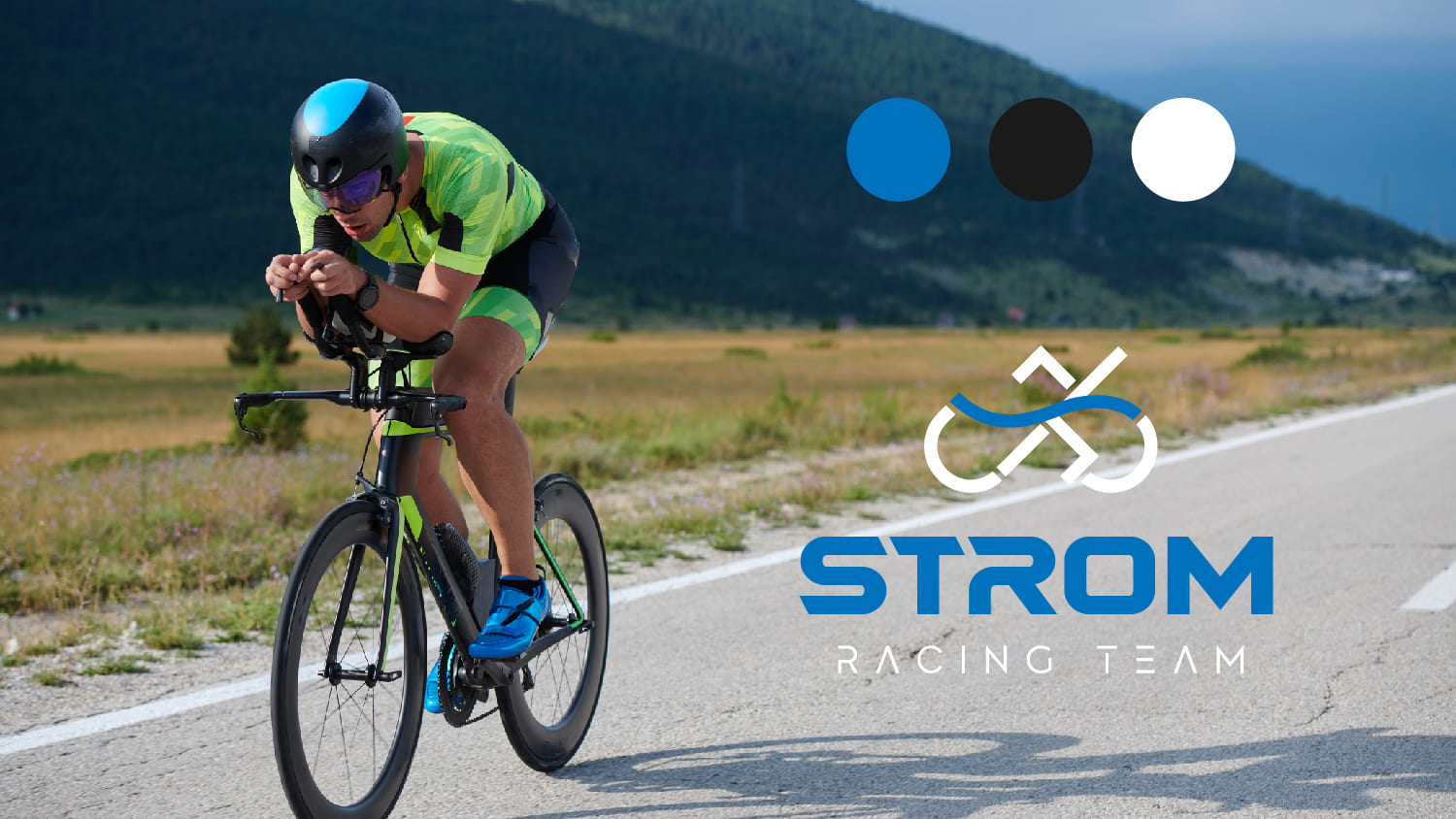 Cyclist on the road with the logo of Ström Racing Team next to