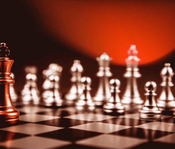 King golden chess standing confront of the silver chess team to challenge concepts of leadership and business strategy management