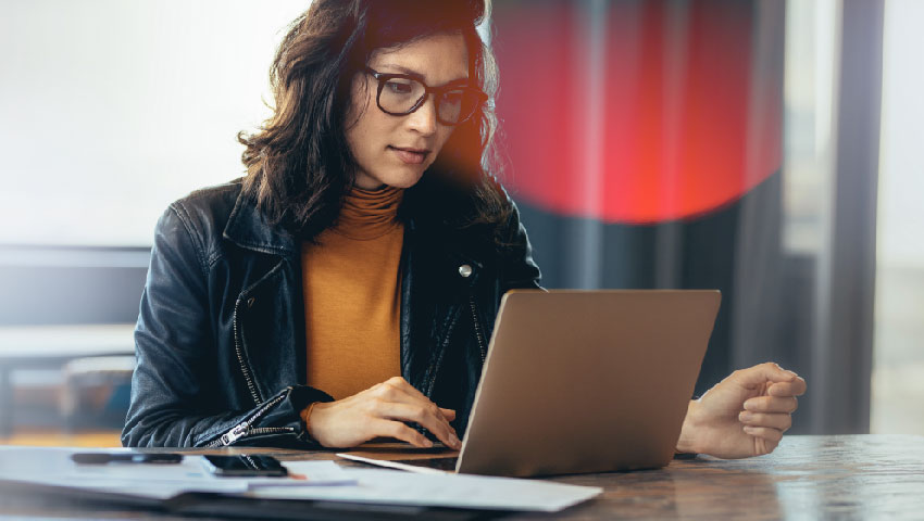 Business woman working on a laptop in a professional office