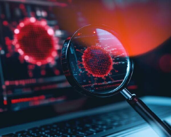 Infographic banner showing a corporate laptop screen with detailed antivirus detection graphs, with a magnifying lens focusing on a phishing malware alert